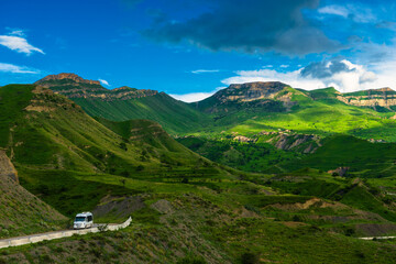 Picturesque mountain landscape with green slopes and road. North Caucasus