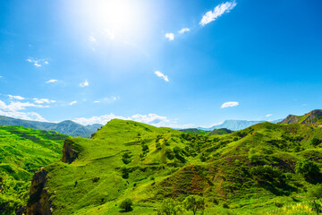 Picturesque mountain view of idealistic landscape of green mountains with deep rocky gorge in sunny...