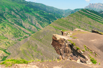 Beautiful view of the flat long rock "Goor Troll's Tongue" above the abyss of a deep mountain gorge of the North Caucasus