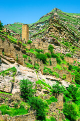 An old watchtower among the ruins of the abandoned mountain village of Kakhib on a mountainside. North Caucasus