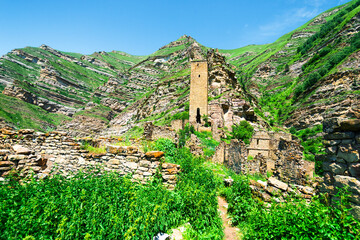 An old watchtower among the ruins of the abandoned mountain village of Kakhib on a mountainside. North Caucasus