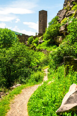 An old watchtower among the ruins of the abandoned mountain village of Kakhib on a mountainside. North Caucasus