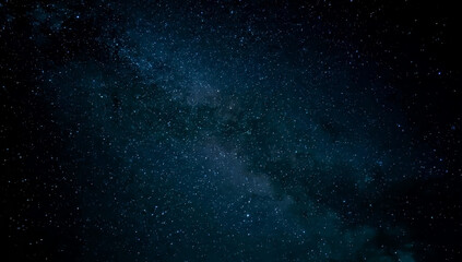 Galaxy exploration through outer space towards glowing milky way galaxy. High quality, beautiful night sky time lapse with Milky Way galaxy on dark sky. Starry night background.