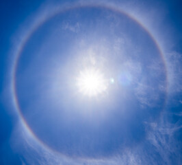 A beautiful rare atmospheric phenomenon of halo in the blue day sky.A halo is an optical...