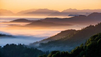 Obraz premium misty mountains with layered fog and soft light at sunrise