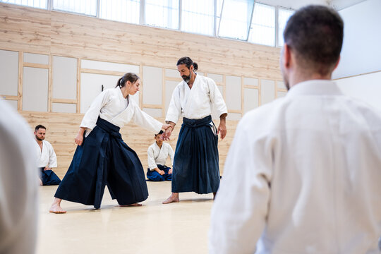 Sensei teaching aikido martial arts to students in dojo