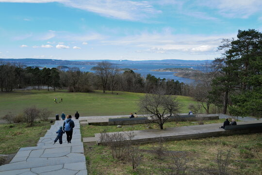 Scenic View of Oslofjord with Visitors Enjoying a Peaceful Park Setting Overlooking the Ocean and Distant Islands in Oslo, Norway