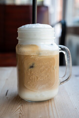 Iced Latte in a glass with a straw in Tournai, Hainaut, Belgium