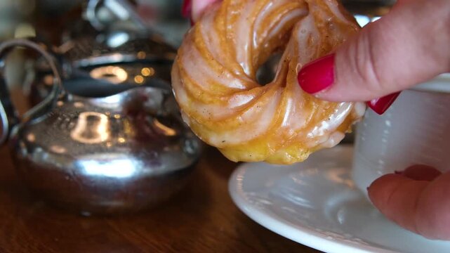 Tea time. Pouring brewed black tea from teapot into transparent cup. Morning breakfast with tea and pastries. . High quality 4k footage