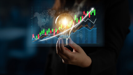 A business professional analyzes stock market trends with a light bulb in hand, symbolizing innovation and insight, as colorful graphs and a world map illuminate the background. Impute