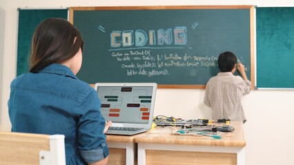 Girl writing engineering prompt by using AI software or programing system to generate AI on table...