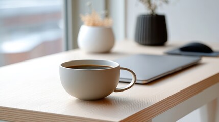 Ceramic coffee mug sitting near laptop, mouse, and potted plant, highlighting comfortable workspace with natural, minimalist home office setting