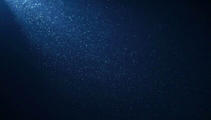 Obraz premium Floating dust particles illuminated by a single cinematic beam of light on a dark gradient background
