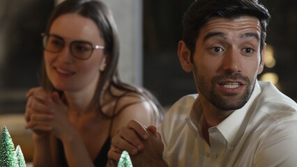 Portrait couple sitting with engaging lively conversation with group friend at luxurious counter bar while waiting cocktail alcohol drinks menu in special festive meeting at pub restaurant. Vinosity.