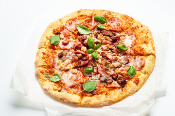 Delicious meat pizza with ham, salami and sausages.