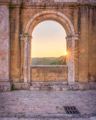 Arched window of the 19th-century aqueduct at sunset in Sorano, Tuscany