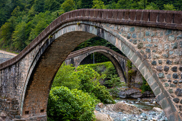 Historical bridges and rivers firtina rivers and cifte bridge Turkey. Old and historic bridges green nature, on river Artvin turkey. ''Cifte Kopru''double bridge area.