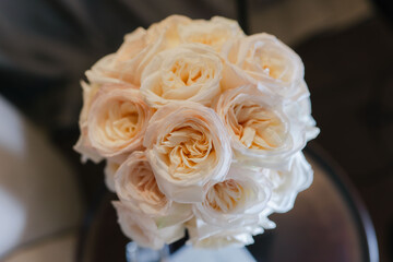 Beautiful bridal bouquet of white roses before the wedding ceremony. Festive decor and floristry. Flowers close-up