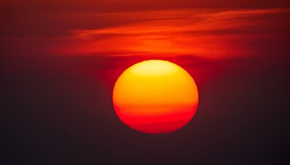 close up of large red sun sunset in the sky