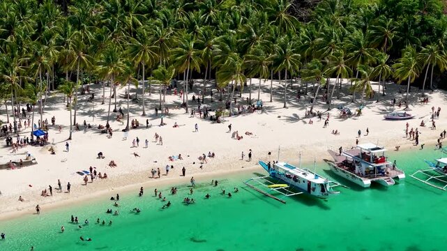 Seven commandos beach in El Nido, Palawan, Philippines islands. Aerial 4K drone video footage. Top view of beautiful turquoise beach, with white sand and palms
