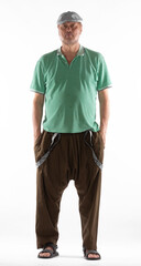 Fototapeta premium portrait of an old man in short pants on a white background