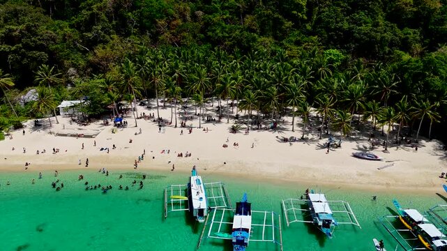 Seven commandos beach in El Nido, Palawan, Philippines islands. Aerial 4K drone video footage. Top view of beautiful turquoise beach, with white sand and palms
