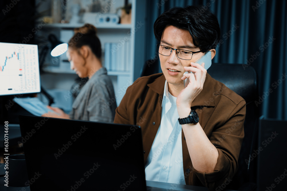 Poster businessman looking on laptop while calling to broker with calculating value margin of profit for th