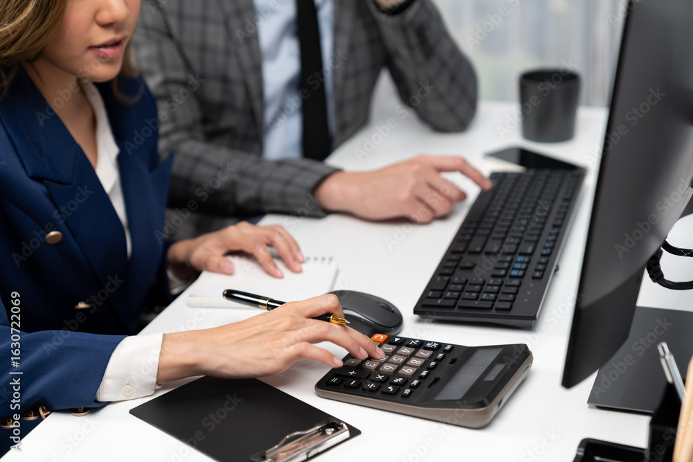 Poster cropped hands businessman with coworker calculating with calculator manual's financial and accountin