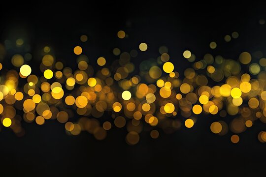 Abstract bokeh lights, gold and yellow circles on a dark background