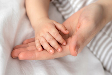 Mother Baby Connection. Mom And Little Newborn Baby Joined Hands Together, Closeup Shot Of Little...