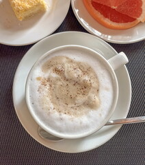 Milk foam with cinnamon in a cappuccino cup