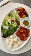 Divided Serving Dish with Lettuce, Tomatoes, Mozzarella, and Olive Oil