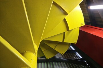 Detail of the colorful spiral staircase inside the observation tower, viewed from below upwards.