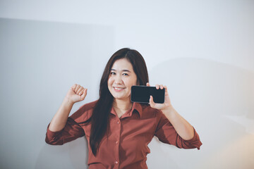 Business asian woman using mobile phone during checking an email or social media on internet....