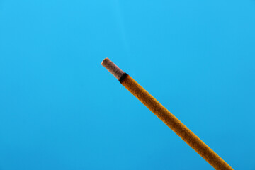 Incense stick on a blue background