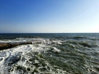 sea and rocks.
view of pier and stormy sea