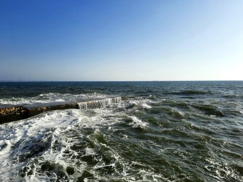 sea and rocks.
view of pier and stormy sea