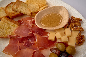 A Fine Selection of Charcuterie with Cured Meats, Cheese, Nuts, and Accompaniments for a Savory Culinary Experience