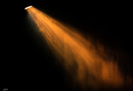 Orange spotlight beam on black background