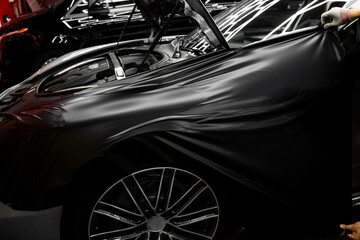 Careful application and tensioning of black vinyl avoids surface damage or bubbling. Car wrapping...