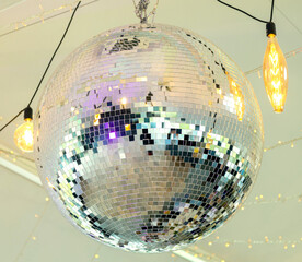Disco ball in the light of the party. The magic of the mirror ball.