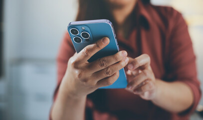 Fototapeta premium Closeup image of a businesswoman using mobile phone in office