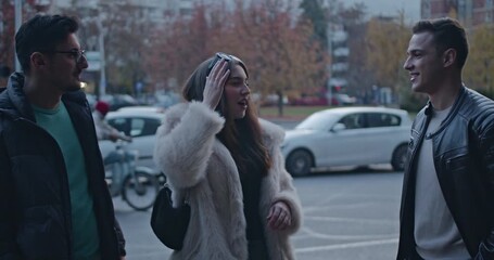 Three friends enjoy a casual stroll through the city, sharing laughter and conversation. The group embraces the urban atmosphere as they walk together. - Powered by Adobe