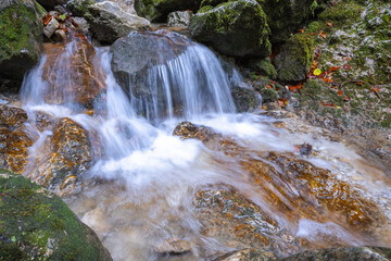 Fototapeta premium Waterfall on a stream in forest at autumn.The rocky gorge Dolne diery in The Mala Fatra National Park, Slovakia, Europe.
