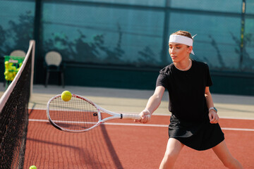 Young Female Tennis Player Returning Ball During Outdoor Training Session on Court