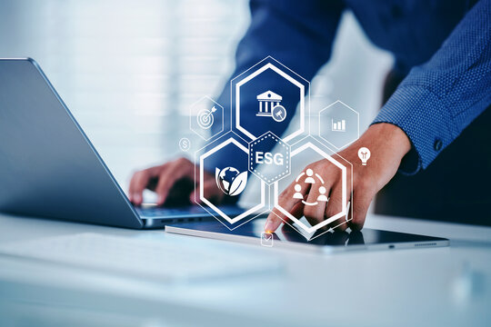 ESG icon of saving clean energy environment social governance concept, Man hand pointing on tablet screen analyze in business investment strategy, green eco friendly, environment, go green, CO2