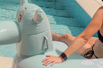 Woman Relaxing by the Pool with Legs in Water, Inflatable Float Ring