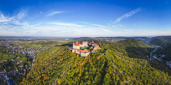 Aerial view of Stift G&Atilde;&para;ttweig monastery perched atop a hill, surrounded by lush forests under a clear blue sky, Krems, Nieder&Atilde;&para;sterreich, Austria.