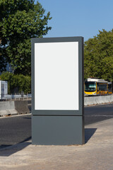 Empty vertical advertising billboard with a blank white screen on a sidewalk in Lisbon, Portugal....