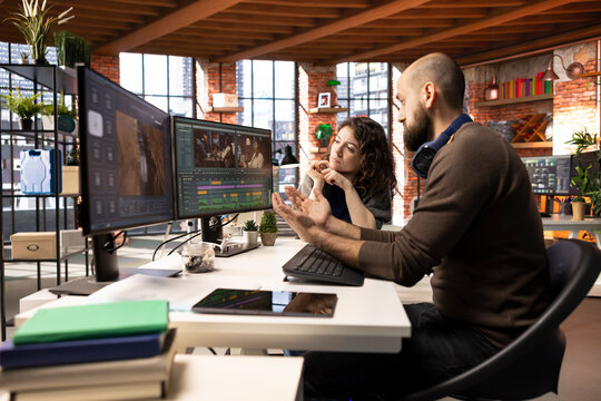 Creative team of editors collaborating on a movie montage project, using AI chatbot and post production software for color grading. Young couple uniting forces for video content.